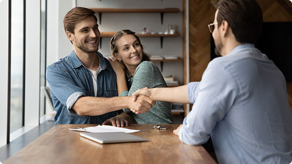A couple discussing a commercial contract with a Sacramento lawyer for a mutually beneficial deal.