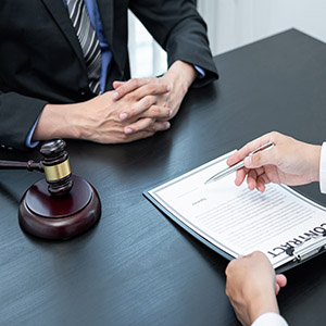 Professional Male lawyer or counselor discussing negotiation legal case with client meeting with document contract in office, law and justice, attorney, lawsuit concept.
